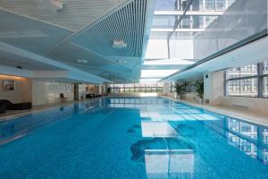 a large swimming pool in a building at Holiday Inn Beijing Focus Square by IHG in Beijing