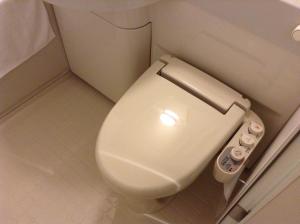 
a white toilet sitting inside of a bathroom at Hotel Century Art in Fukuoka
