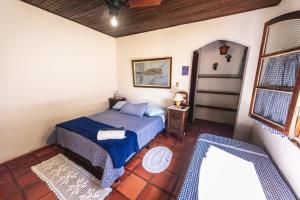 Кровать или кровати в номере Pousada da Gibinha