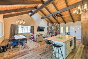 a kitchen and living room with wooden ceilings at Pine Mountain Cabin with Hot Tub, 2 Mins to Marina! in Groveland