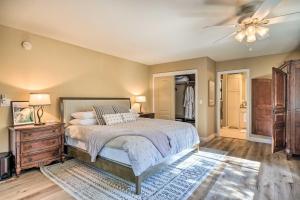 a bedroom with a bed and a ceiling fan at Pine Mountain Cabin with Hot Tub, 2 Mins to Marina! in Groveland