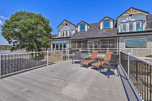 a house with a wooden deck with chairs on it at Lavish Lake House, Near Vineyards and Marinas! in Granbury