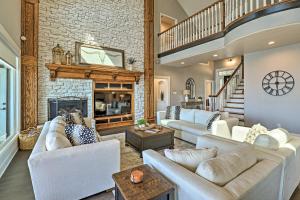 a living room with white furniture and a brick wall at Lavish Lake House, Near Vineyards and Marinas! in Granbury