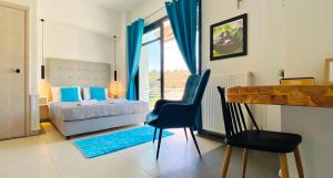 a bedroom with a bed and a desk and a chair at Rethymno Hills in Rethymno Town