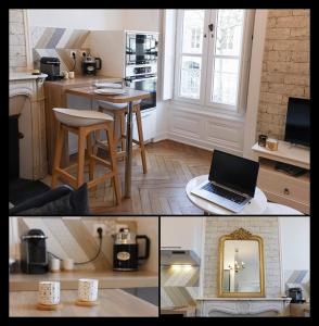 a kitchen with a laptop computer on a table at Appartement cosy proche gare in Angers