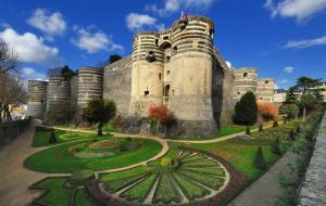 a large castle with a garden in front of it at Appartement cosy proche gare in Angers