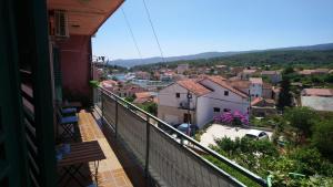 a balcony of a house with a view of a city at Apartman Nađa in Vrboska