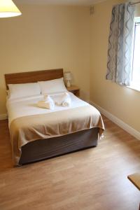 a bedroom with a bed with two towels on it at Tralee Town Centre Apartments in Tralee