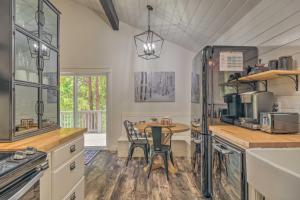 a kitchen with a table and a dining room at Chic and Modern Escape about 4 Mi to Pinecrest Lake! in Cold Springs