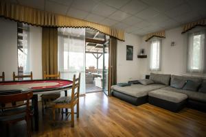 a living room with a couch and a table at Forrás vendégház in Dunaegyháza