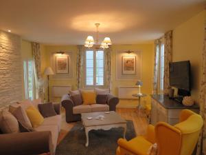 un soggiorno con un divano e una TV di La Maison de Riviere a Bourg-Charente