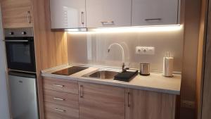 a kitchen with a sink and a microwave at Onar View Studio in Néa Péramos
