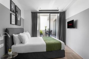 a hotel room with a bed and a dining room at Play Theatrou Athens in Athens