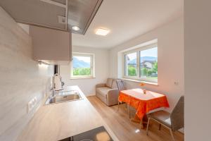 a small kitchen with a table and a couch at Haus Stolz in Appiano sulla Strada del Vino