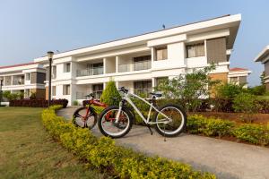 two bikes parked in front of a building at Mizzle Exotica Lonavala in Lonavala