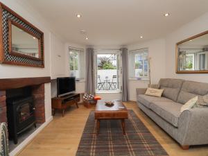 a living room with a couch and a fireplace at Lower Deck in Bexhill