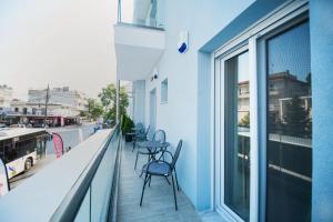 - un balcon avec des chaises et des tables dans un bâtiment dans l'établissement NIKI'S apartments, à Peraia