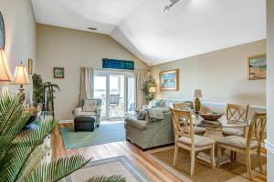 a living room with a couch and a table at Pelican Watch 1380 in Seabrook Island