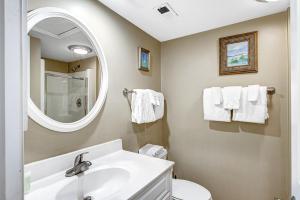 a bathroom with a sink and a mirror at Pelican Watch 1380 in Seabrook Island