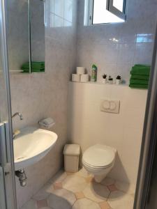 a white bathroom with a sink and a toilet at Silver Beach Resort in Zamárdi +37 photos