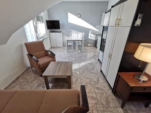 a living room with a couch and a table at Silver Beach Resort in Zamárdi
