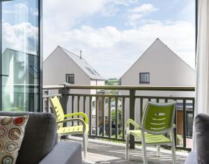 a balcony with two chairs and a couch at Rainer Rocks in Polzeath