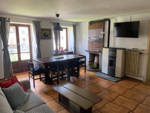 a living room with a table and a couch at Dépendance 1816 in Morgex