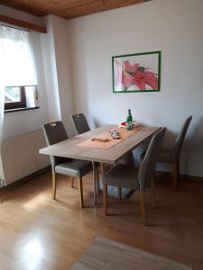 a dining room with a table and chairs at Haus Rosi in Weiskirchen