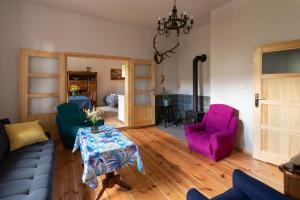a living room with a couch and two chairs at Nowe Kawkowo 28 in Jonkowo
