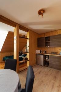 a kitchen with a table and chairs in a room at Nowe Kawkowo 28 in Jonkowo