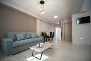a living room with a couch and a table at NIKI'S apartments in Perea