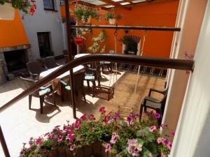 a balcony with a table and chairs and flowers at Ubytování Apartmány Ferenčíková in Nové Hrady