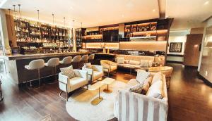 a restaurant with a bar with couches and chairs at Hotel 93 Luxury Suites by Preferred in Bogotá