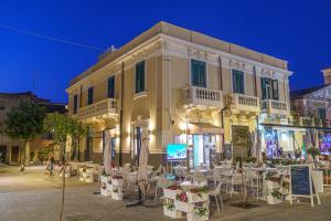 a building with tables and chairs in front of it at PLAZA Boutique Hotel - Tropea in Tropea
