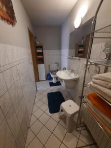 a bathroom with a sink and a toilet at Ferienhaus Waterstrat in Stolberg i. Harz +14 photos