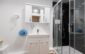 a bathroom with a shower, sink, and toilet at Central Hoxton Shoreditch in London