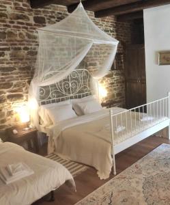 a bedroom with a bed with a mosquito net at Casa Marta in Bărcuţ