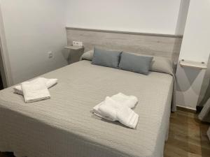 Postel nebo postele na pokoji v ubytování alojamiento saturno1