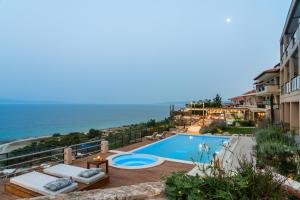 a swimming pool with a view of the ocean at Rigas Boutique Hotel & Spa in Afitos