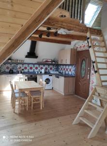 a kitchen with a table and a dining room at art-house 4 Attic Apartment in Děčín