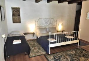 a bedroom with a bed and a crib in it at Casa Marta in Bărcuţ
