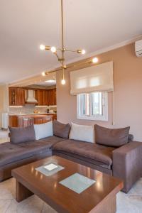 a living room with a couch and a table at Kanali Hill House in (( Agía Eleoúsa )) +22 photos