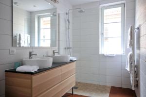 a bathroom with two sinks and a mirror at Au Grenier à Sel Colmar in Colmar +6 photos