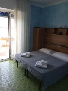 Voodi või voodid majutusasutuse Albergo Stella Di Mare toas