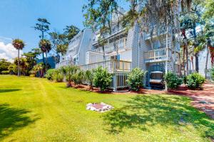 a large apartment building with a large yard at Driftwood Villa - 280 in Edisto Beach