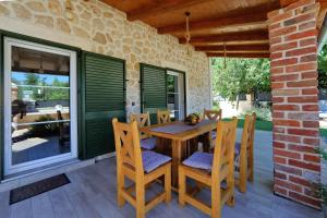 a wooden table and chairs on a patio at Stone Diamond in Zadar