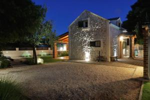 a stone house with lights on the side of it at Stone Diamond in Zadar