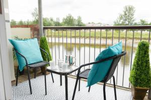 a patio with two chairs and a table on a balcony at 7 Camelside in Wadebridge
