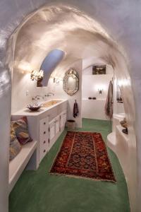 a bathroom with two sinks and a rug at Hiraeth Santorini in Megalokhori