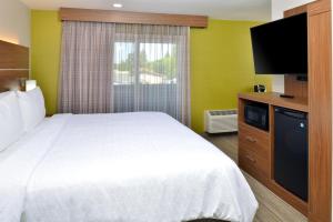 a hotel room with a bed and a flat screen tv at Holiday Inn Express - Santa Rosa North by IHG in Santa Rosa